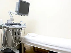 院内のエコー装置と検査用のベッド